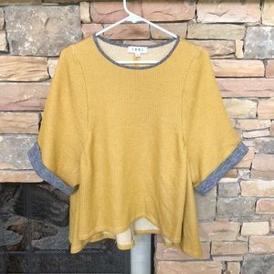Mustard blouse with gray sleeve cuffs